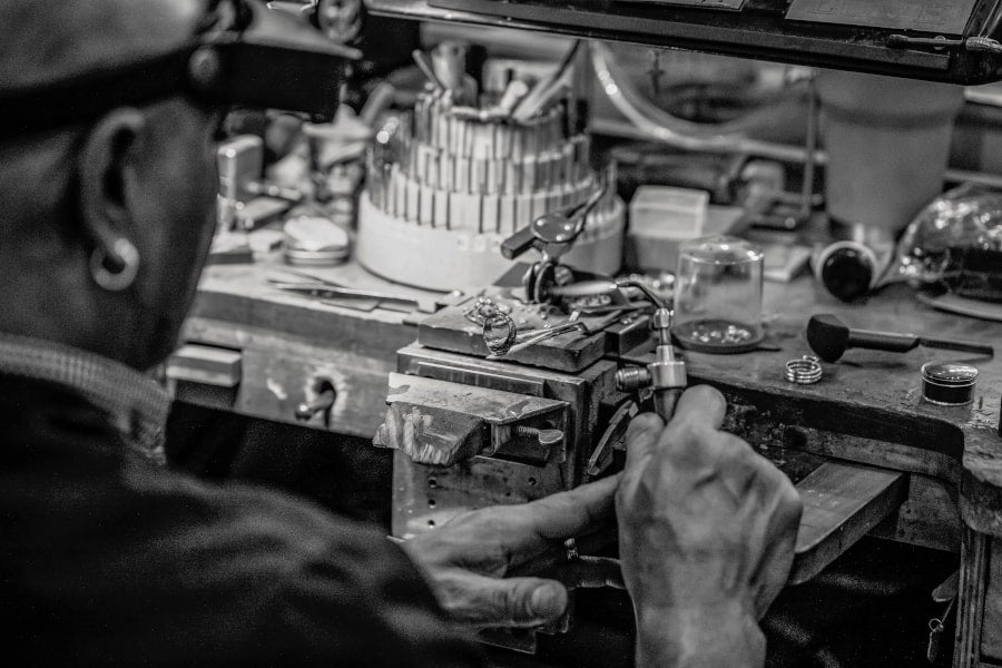 Black and White Photo of a Jeweler at Their Workbench
