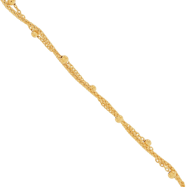 Close-up of twisted gold chains with small gold beads